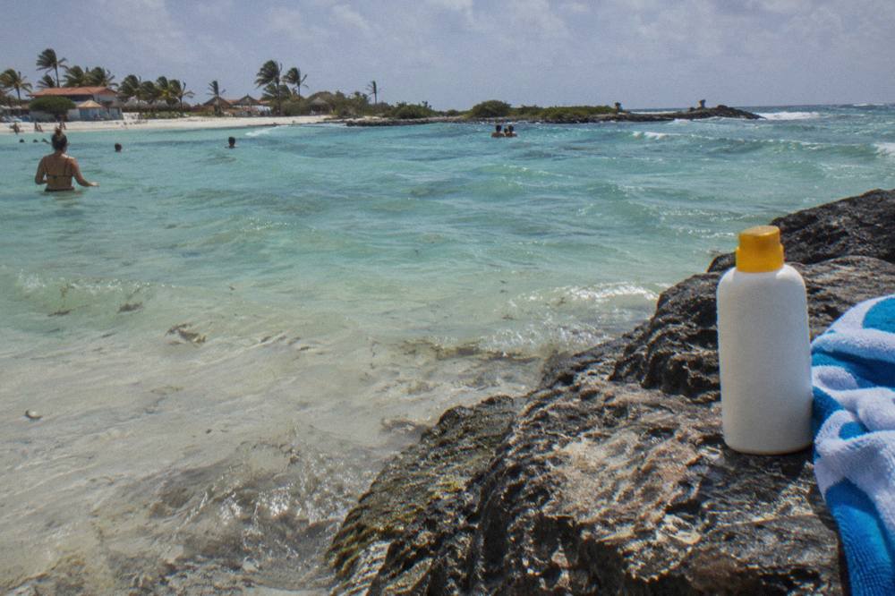 A clear shallow bay with a fringe of reef and calm water above pale sand