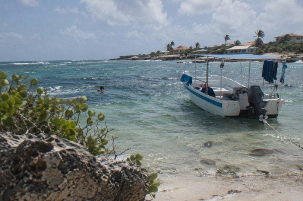 Snorkel boat anchored over a shallow reef in clear blue water