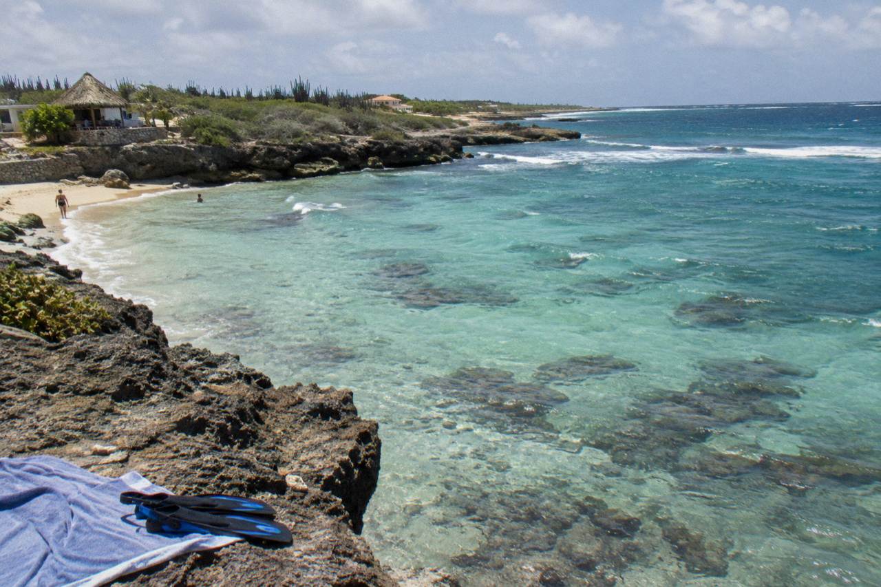 Calm turquoise water over a shallow reef with scattered coral heads