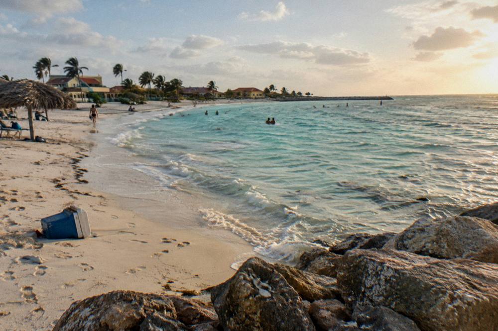 Shallow turquoise water along a white sand beach with gentle waves