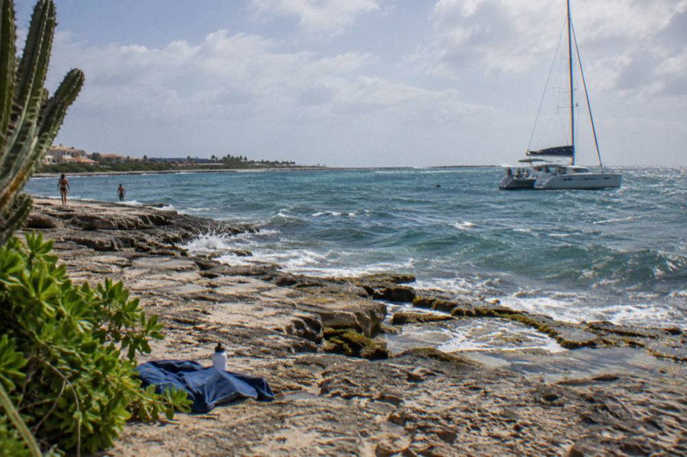 A catamaran anchored near a reef in calm blue water