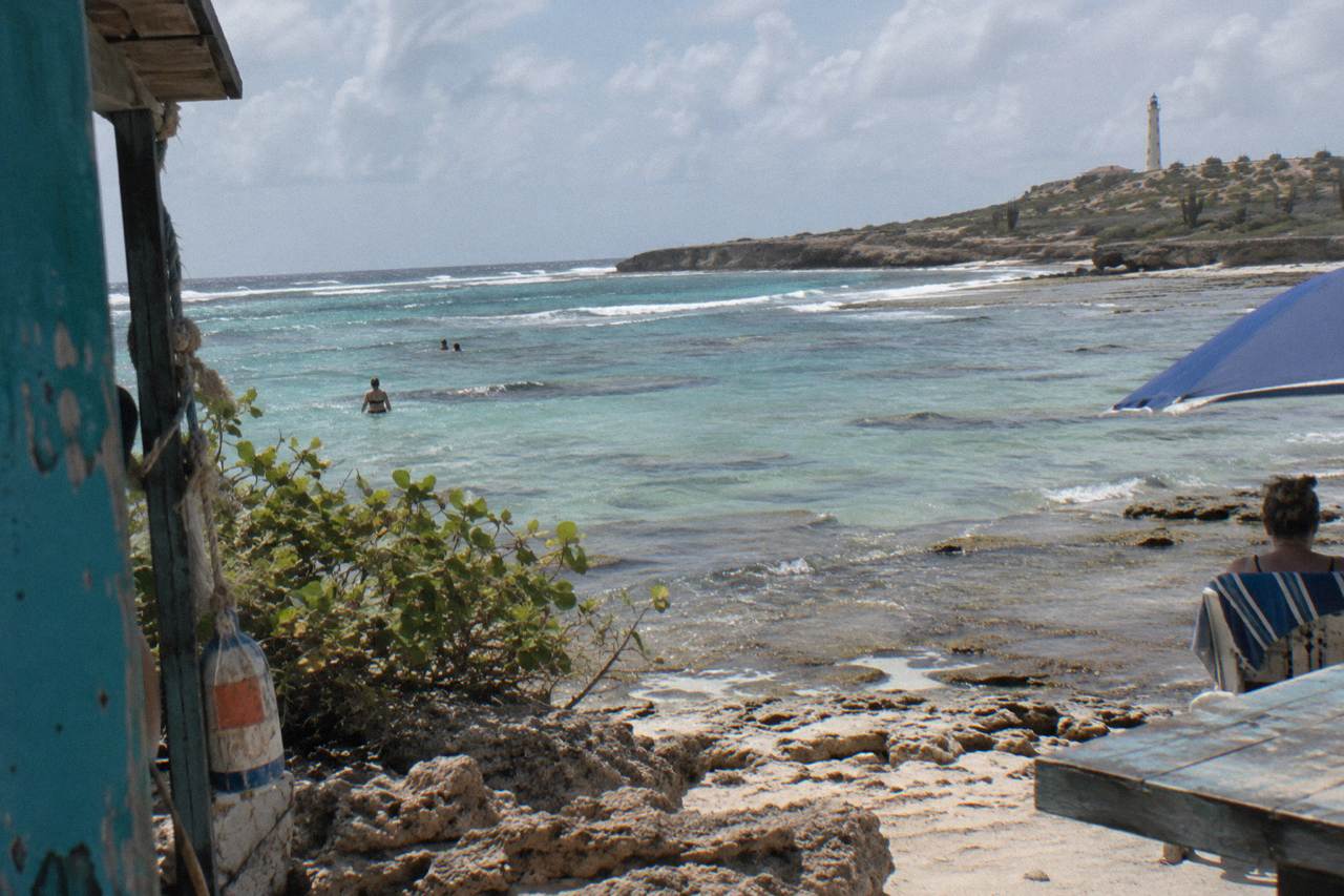 Calm turquoise water over a shallow reef close to an Aruba beach