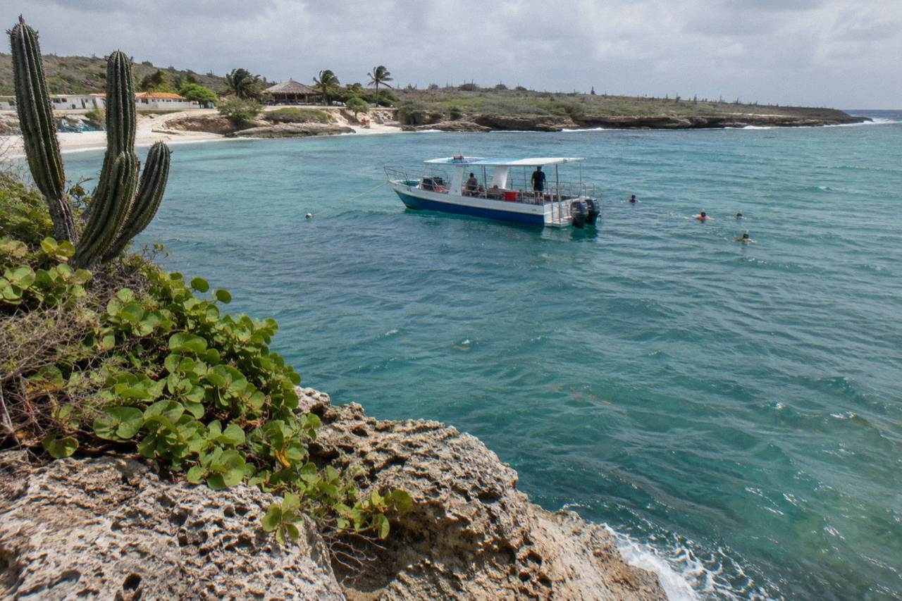 Calm turquoise water along Aruba's leeward coast with a snorkel boat anchored offshore