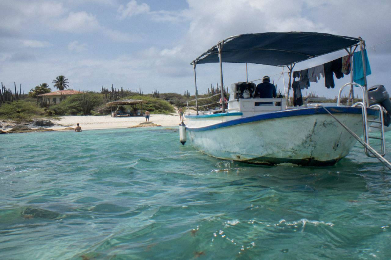 Snorkel boat anchored over a calm reef in clear turquoise water