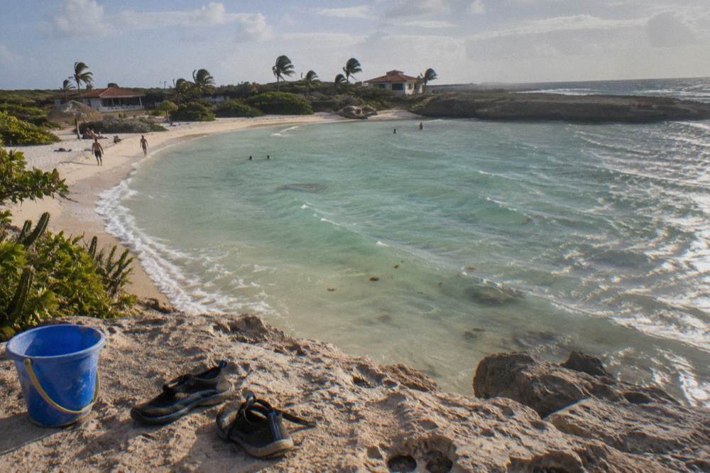 A shallow lagoon-style bay with pale sand and gently rippling clear water